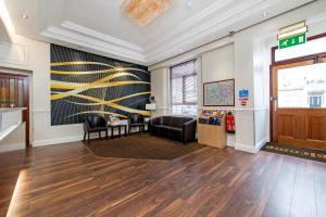 a lobby with a waiting area with chairs and a waiting room at Lidos Hotel in London