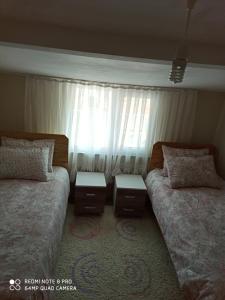 a bedroom with two beds and a window at Denize sıfır 2 yatak odalı daire D 8 in Tekirdag