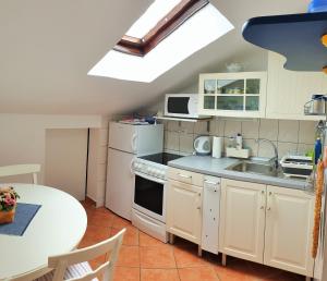 a small kitchen with a sink and a table at RentFox - Crikvenica in Crikvenica