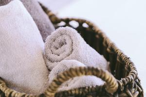 a wicker basket filled with towels at Capitol Executive Apartment on London Circuit in Canberra