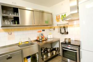 a small kitchen with a sink and a stove at Townside Hostel Bremen in Bremen
