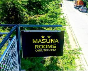 a sign that says maximilian rooms on a fence at Maslina Rooms in Smederevo
