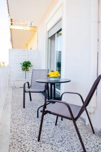 a patio with a table and chairs on a rug at La casa di pasqui in SantʼAntonio Abate