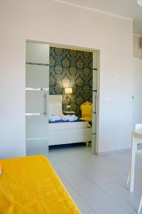 a bedroom with a bed and a door to a room at La casa di pasqui in SantʼAntonio Abate