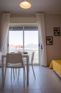 a dining room with a table and a window at La casa di pasqui in SantʼAntonio Abate