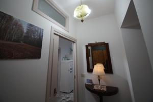 a room with a hallway with a lamp and a mirror at B&b Sant'Agata in Sant'Agata de' Goti +59 photos