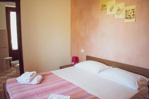 Postel nebo postele na pokoji v ubytování L'Antica Passolara