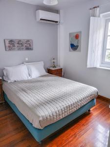 A bed or beds in a room at Pine Trees and Sea View Houses in Hydra - Daphne, Chloe, Myrto, Eleni