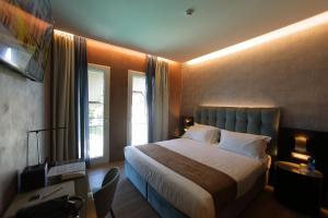a hotel room with a bed and a television at Hotel Bell'arrivo by Dori in Peschiera del Garda