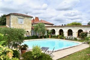 an estate with a swimming pool and a house at Les Écuries de Saint Sever in Saint-Sever