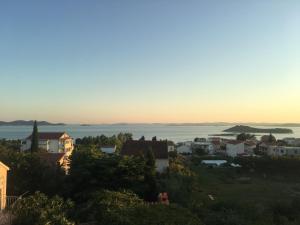a view of a city with the ocean in the background at Francis Appartements in Pakoštane