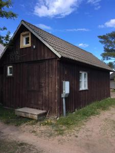 a wooden building with a door and a window at Vahtra Beach House in Käsmu