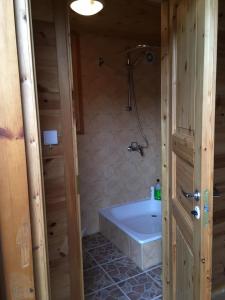 a bathroom with a bath tub and a shower at Vahtra Beach House in Käsmu