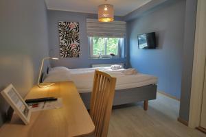 Postel nebo postele na pokoji v ubytování Hotell Munkeröd