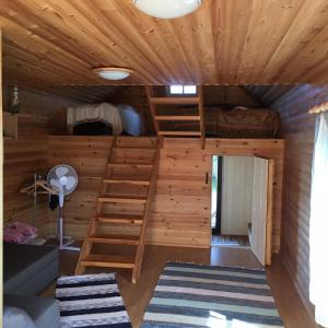 a room with bunk beds in a log cabin at Vahtra Beach House in Käsmu