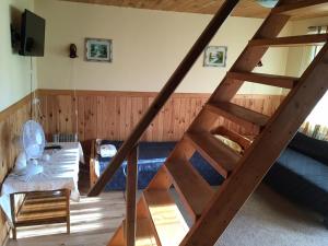 a staircase in a room with a bed and a couch at Vahtra Vacation Houses in Käsmu