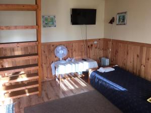 a bedroom with two beds and a flat screen tv at Vahtra Vacation Houses in Käsmu