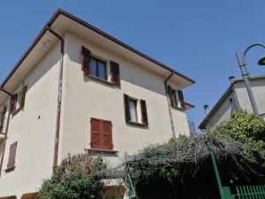 a white building with windows and a street light at Mille papaveri rossi Casa di Angela in Serravalle di Chienti