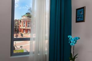 a window with a view of a city street at Opera Family Hotel - former City Mark hotel in Varna City
