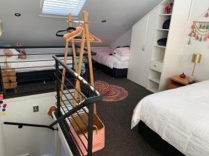 a small room with a bed and a staircase at Sorrento Back Beach Apartment at Oceanic Apt 7 in Sorrento