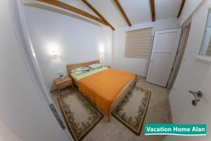 a small bedroom with a bed in a room at Vacation home Alan 2 in Kulen Vakuf +73 photos