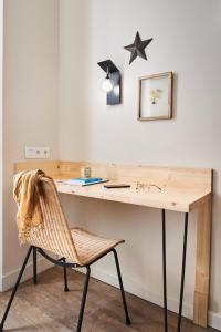 a desk with a chair and a star on the wall at Hôtel Stanley by HappyCulture in Nancy