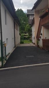 an empty parking lot between two buildings at Apartma Pr Maruši in Bovec