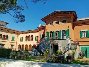 a large building with a staircase in front of it at Villa Colle Olivi in Pescia