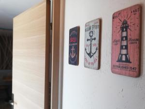 a door with three stickers on a wall at Le Sémaphore - studio climatisé, grande terrasse vue mer - parking, wifi in La Grande Motte