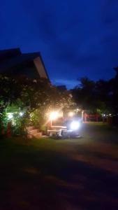 a truck parked in front of a building at night at สุขกมลรับอรุณแฝด2ห้อง in Chanthaburi