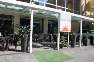 a patio with tables and chairs and a sign at Hotel Vernel in Rimini +45 photos