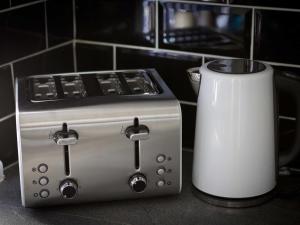 a toaster and a toaster sitting on a counter at Copperfield House in Leeds