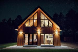 a house with glass windows and lights on it at Newlands Lodges in Shotley Bridge