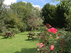 a picnic table and flowers in a garden at Recruiting Sergeant in Norwich