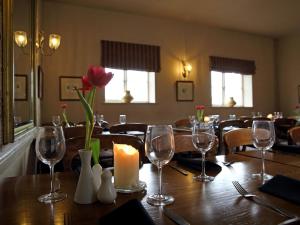 a dining room with a table with a candle and wine glasses at Recruiting Sergeant in Norwich