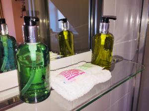 três garrafas de sabão num balcão na casa de banho em Shrubbery Guest House em Worcester