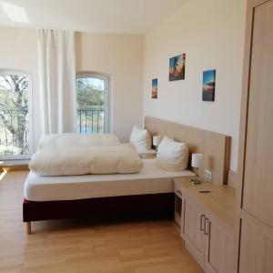 a bedroom with two beds and a window at Landhotel kreien in Kreien