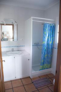 a bathroom with a shower with a sink and a mirror at Complejo Vacacional Los Cortijillos-Solo adultos in Conil de la Frontera +15 photos
