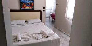 a bedroom with a bed with towels on it at Ladies Beach Hotel in Kuşadası