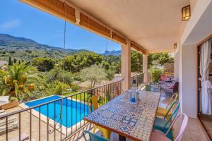 a balcony with a table and a view of a pool at Casa Caterina in Port de Soller