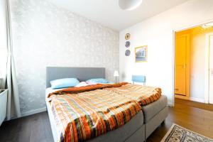 a bedroom with a bed and a dresser at Hello B&B Utrecht in Utrecht