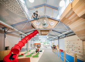 a large indoor climbing gym with a slide at JUFA Hotel Vulkanland in Gnas