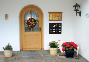 a door with three potted plants in front of it at Ferienhaus Rosa 2 & 5 in Füssen