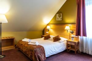 Łóżko lub łóżka w pokoju w obiekcie Eco Active Resort PIENINY