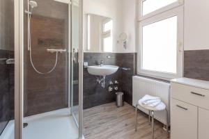 a bathroom with a shower and a sink at Villa Meeresgruss in Ostseebad Sellin