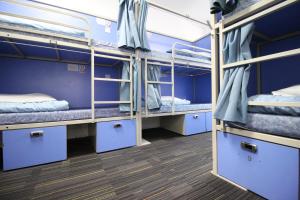 a room with three bunk beds on a bus at Smart Hyde Park Inn Hostel in London