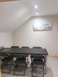 a conference room with a black table and chairs at Reubens Loft for 1 to 6 person Family 4 miles outside Portrush Bushmills Coleraine Ballymoney in Bushmills