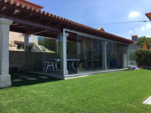 a house with glass doors and a yard at Playa America! in Nigrán