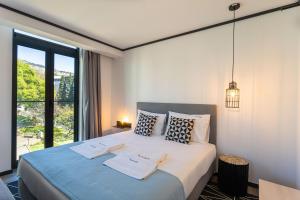um quarto com uma cama grande com duas toalhas em Studios Heart of Funchal Traveller Hideaway em Funchal