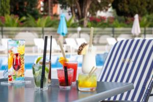ein Tisch mit Getränken und einem Stuhl in der Unterkunft Hotel Bolero in Biograd na Moru